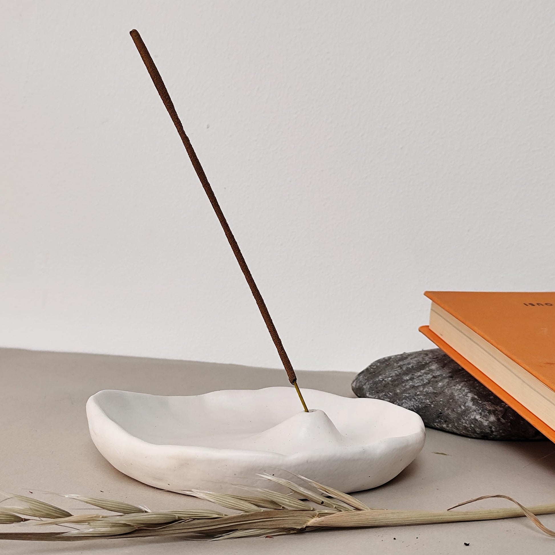 inscense stick in white burner book in. background