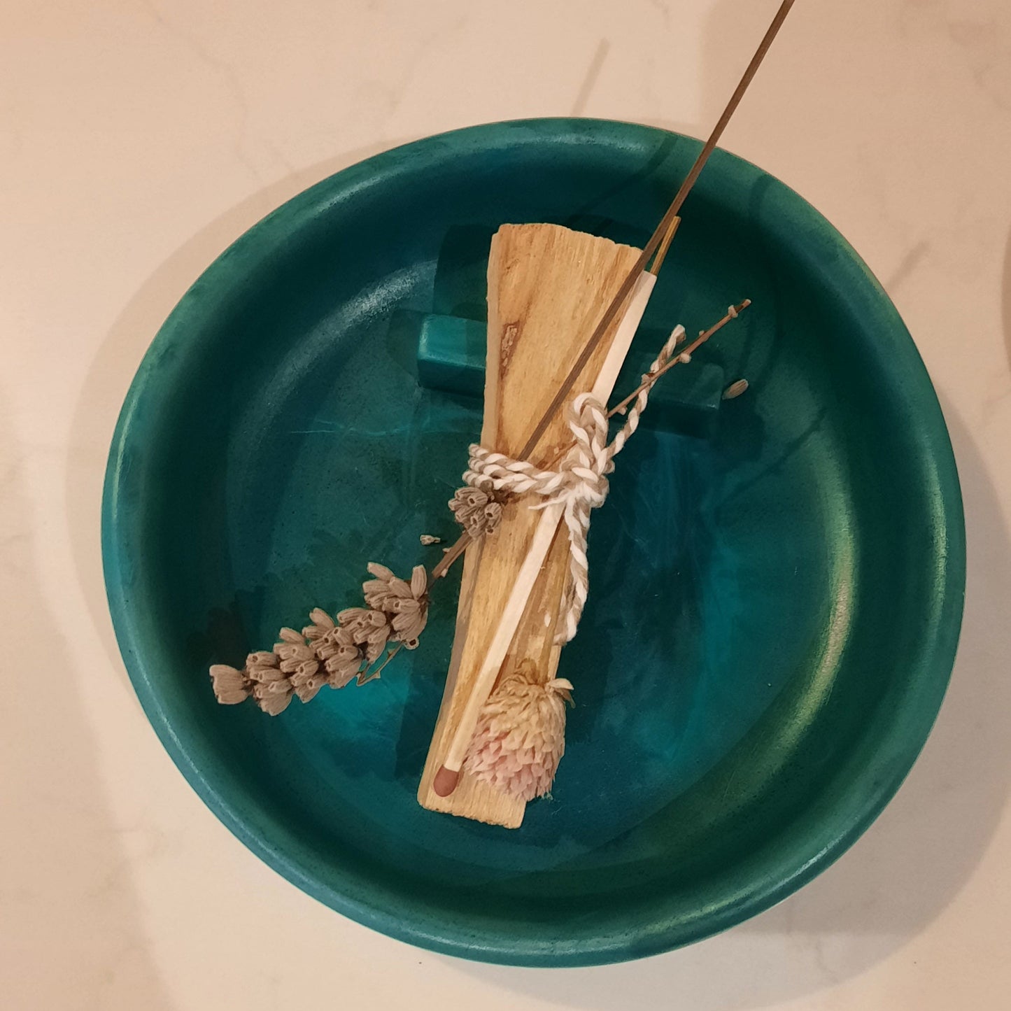 Overview shot of Handmade burner with a palo santo stick place on top
