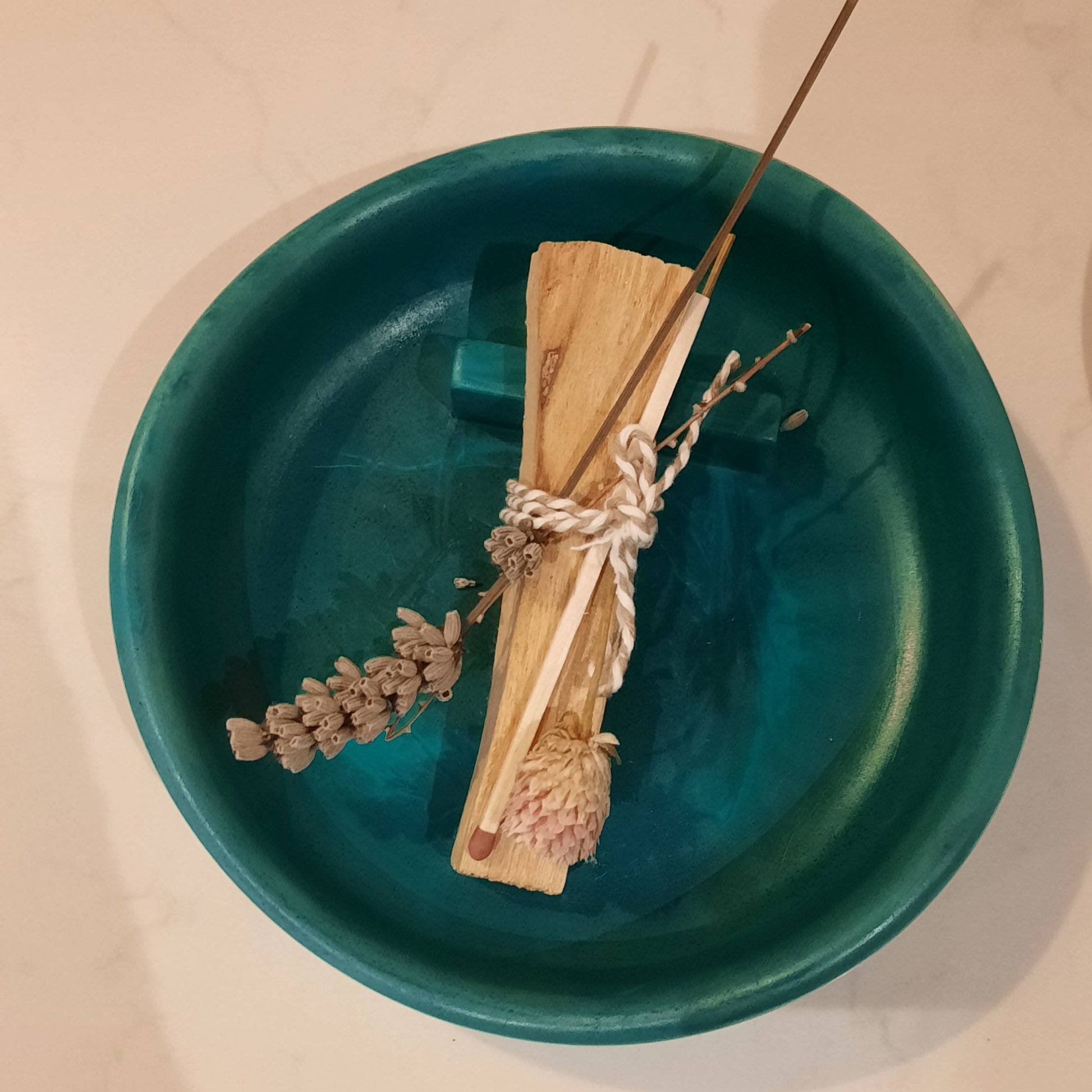 Overview shot of Handmade burner with a palo santo stick place on top