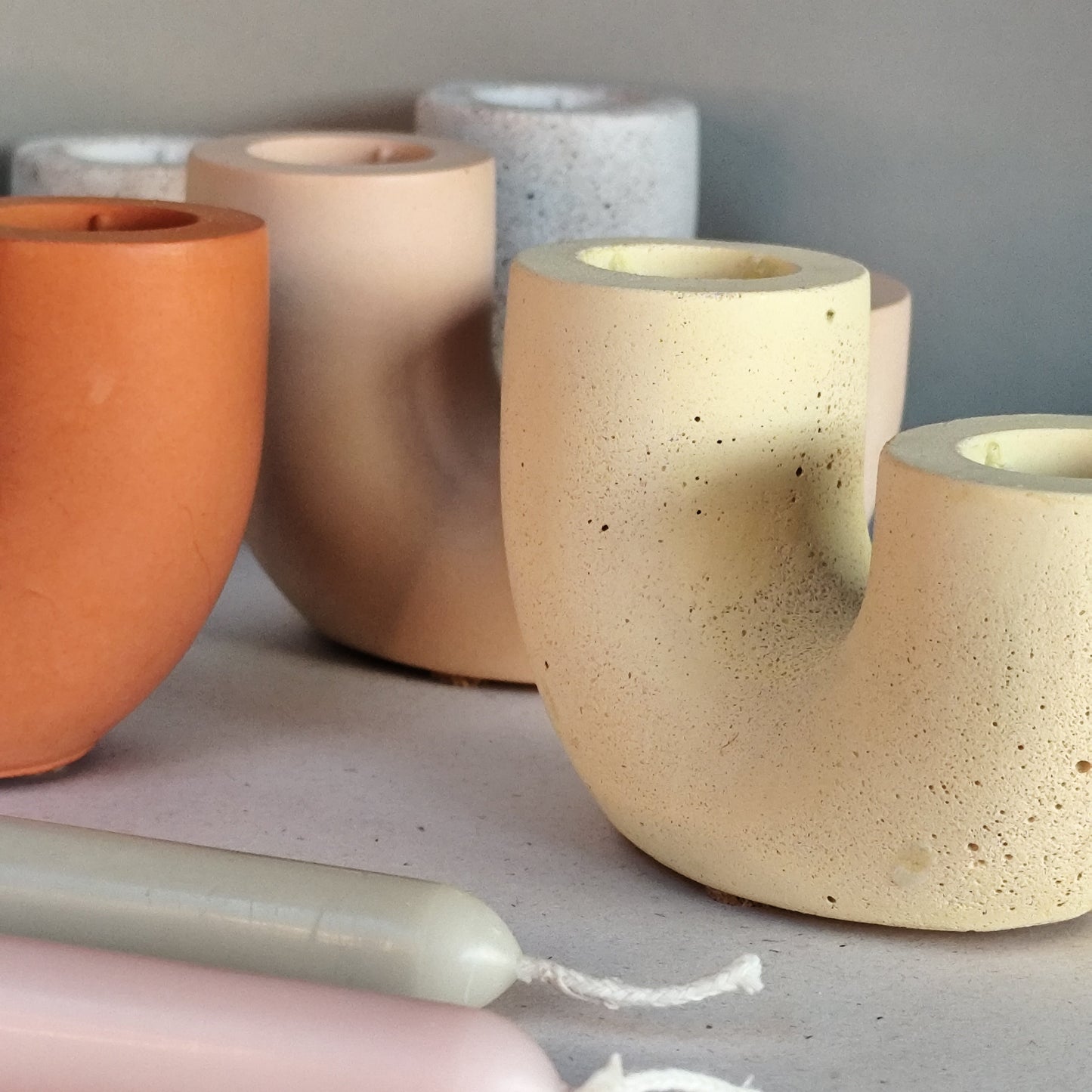 Four duo candle holders together showing smooth texture and rough texture in earthy tone colours