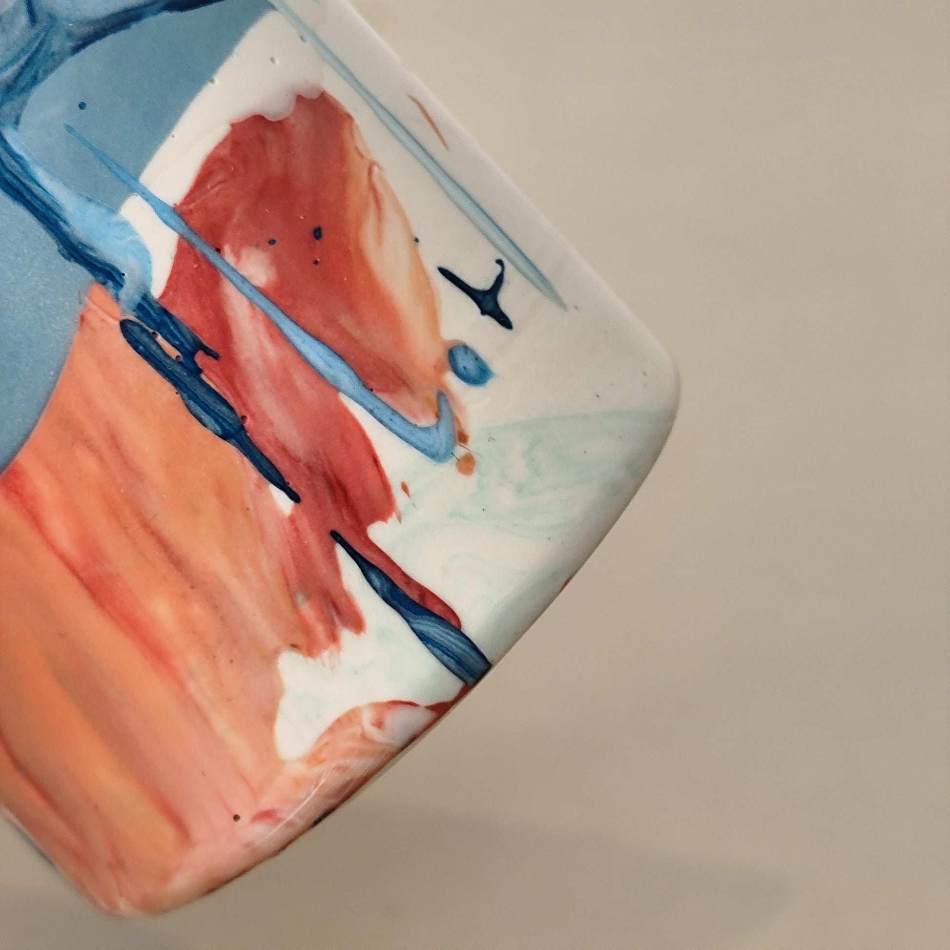 close up of abstract pattern on vase rust and blue