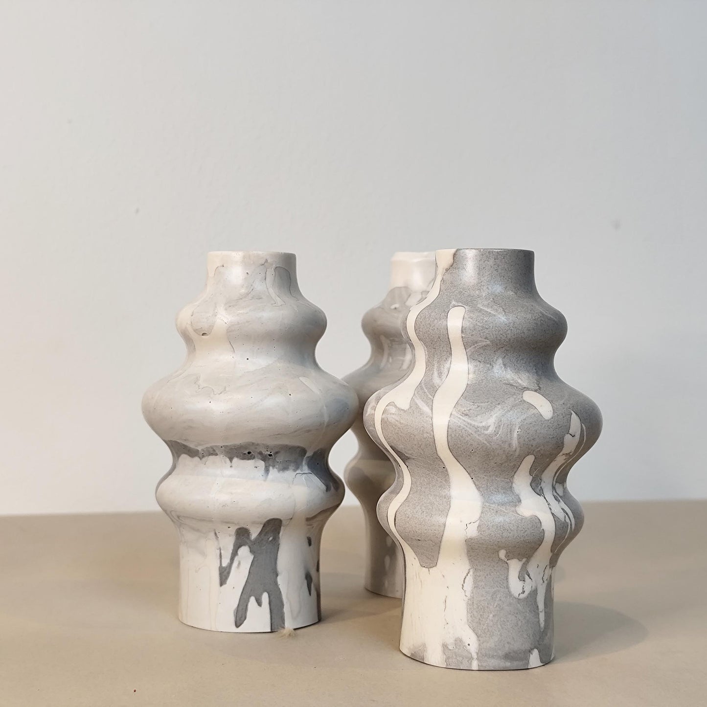 Two curves grey toned vases on a neutral background