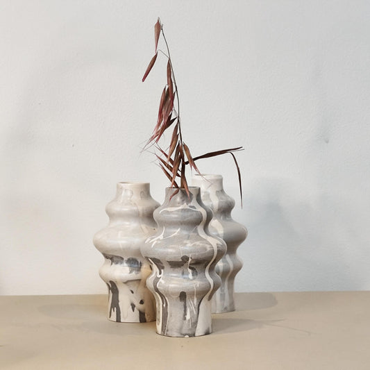 Set of three jesmonite vases with a marble drip design on a neutral background