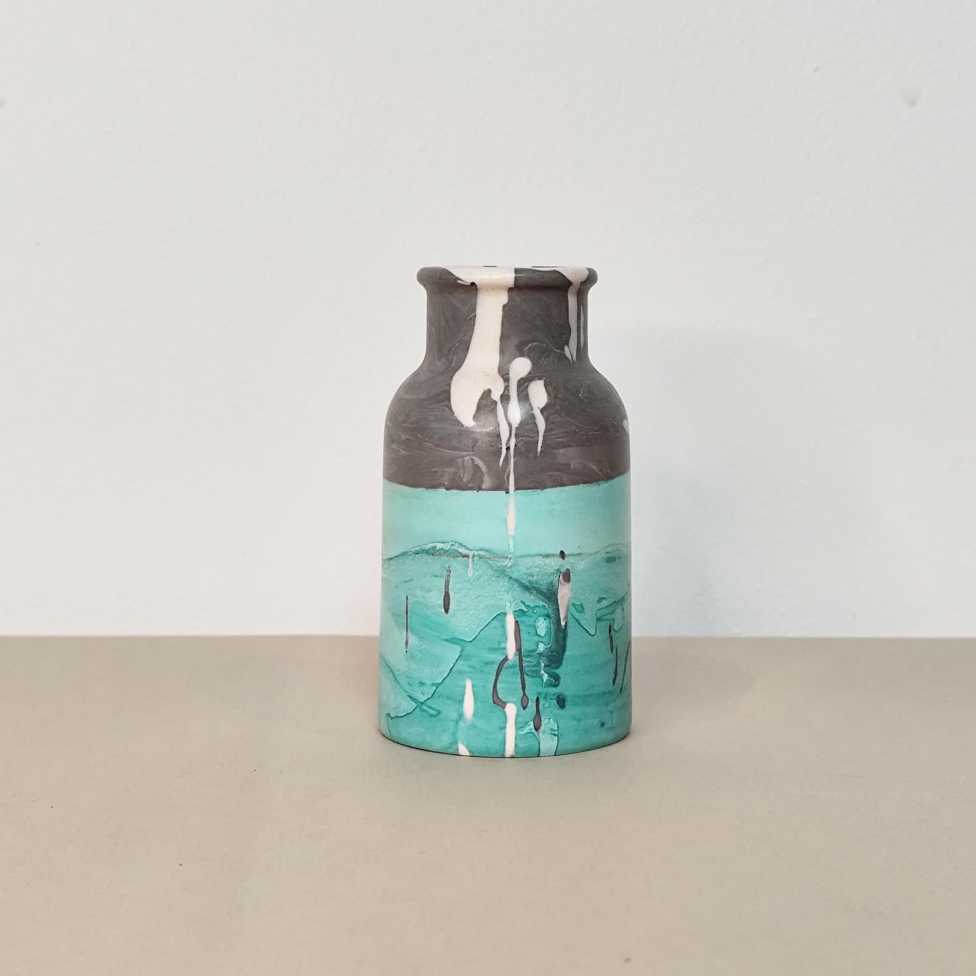 splat drops on grey and green vase