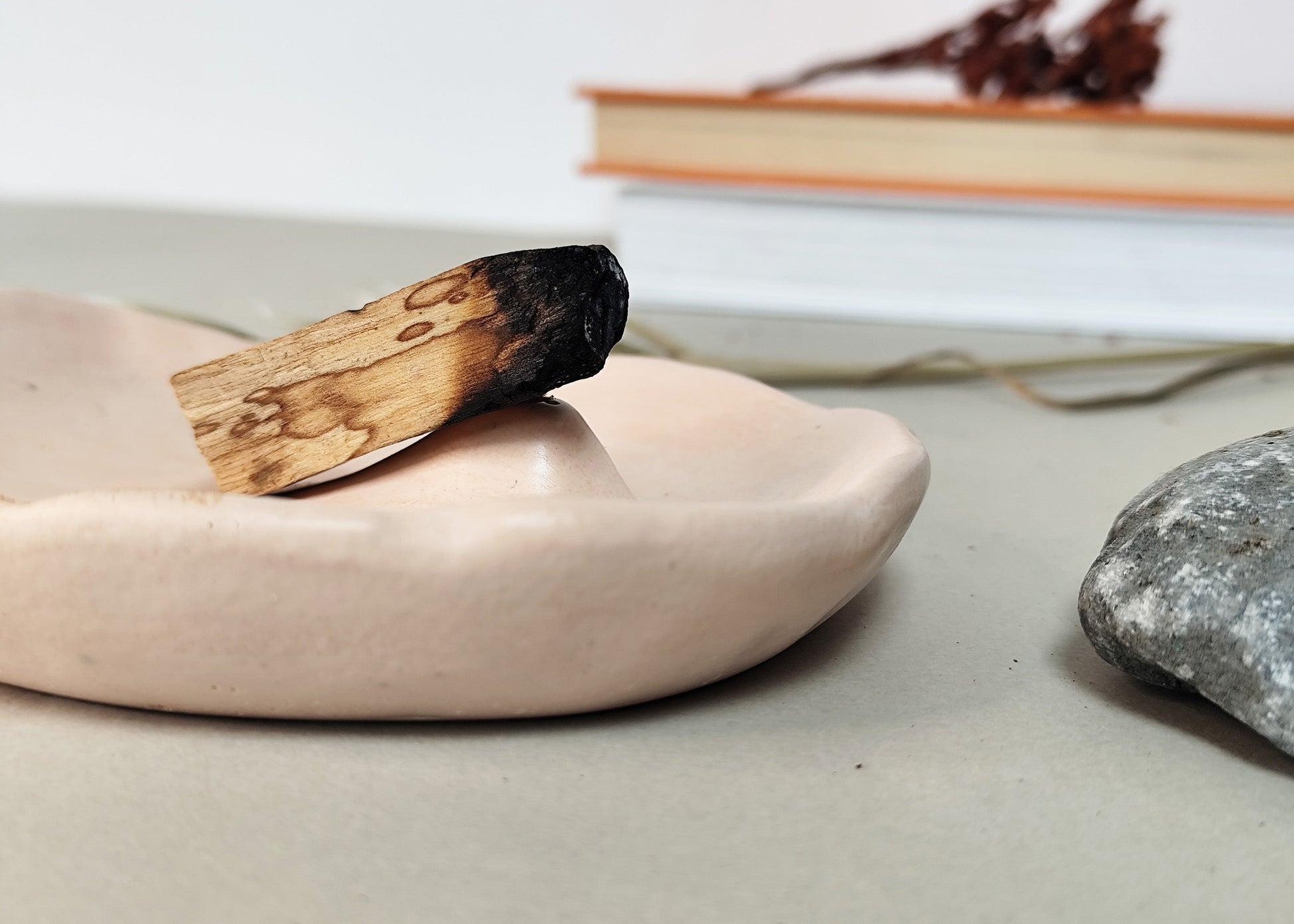 Modern incense burner with a palo santo dish on a on a neutral background